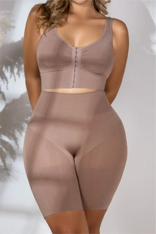 Woman wearing hips and thighs shaping shorts with supportive bra in beige