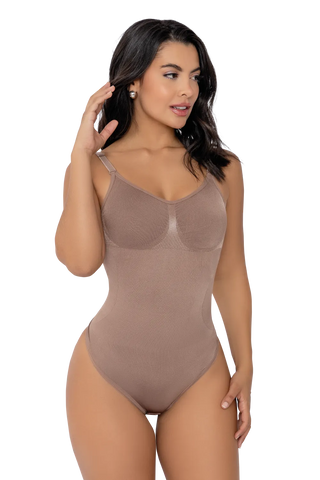 Front view of a woman modeling the Mocha Seamless Sculpting Low Back Thong Bodysuit from Jackie London