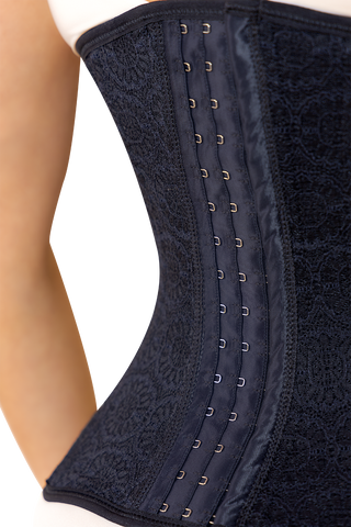 Back view of a woman wearing Black Ultimate Corset shapewear by Jackie London